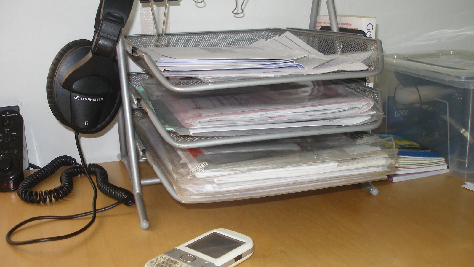 Letter trays and paper sorting setup on an office desk